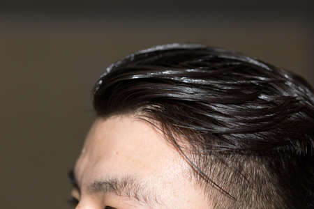 hair combed back to a young man's head close-upの写真素材