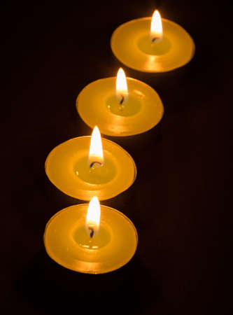 Group of burning candles on black backgroundの写真素材