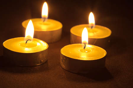 Group of burning candles on black backgroundの写真素材