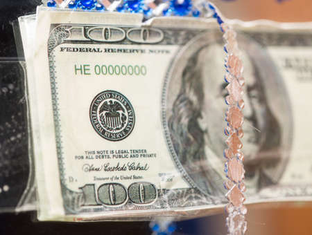 hundred dollars in a mirror close-upの写真素材