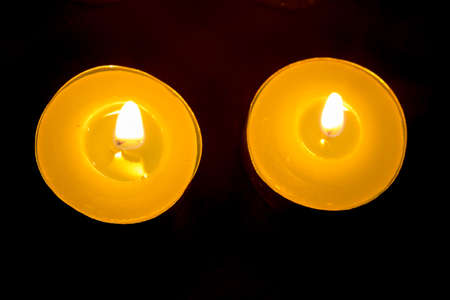 Group of burning candles on black backgroundの写真素材