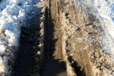 Snowy road with car tracesの写真素材