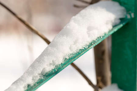 Snow on the fence macroの写真素材