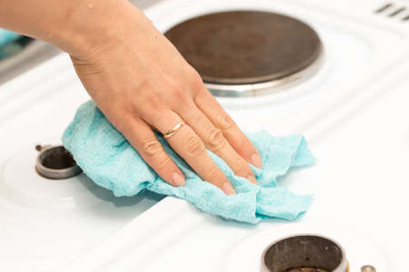 woman washes a gas stoveの写真素材