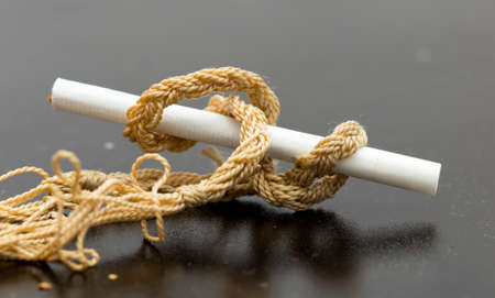 Cigarette on a black table close-upの写真素材