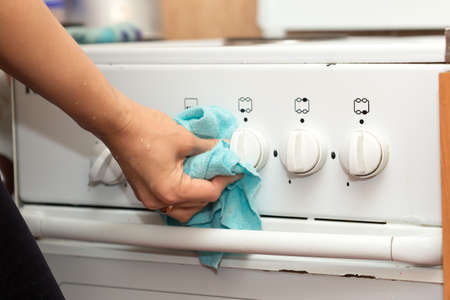 woman washes a gas stoveの写真素材
