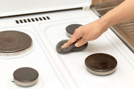 woman washes a gas stoveの写真素材