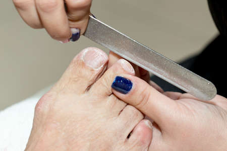 Pedicure in salon. The process of cleaning the feetの写真素材