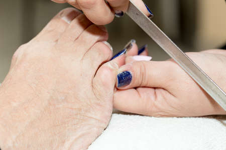 Pedicure in salon. The process of cleaning the feetの写真素材
