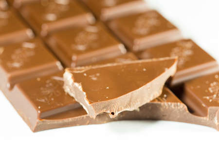 Broken chocolate bar left position isolated on white table. Horizontal composition. Top viewの写真素材