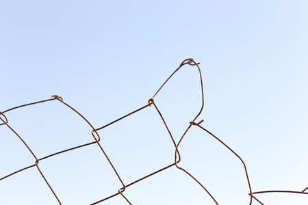 Metal fence against the skyの写真素材