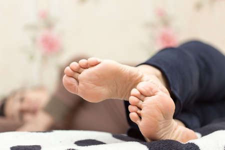 Feet of women in bed