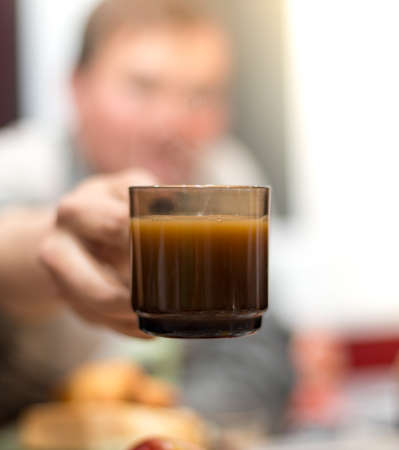 Man offers a cup of coffee