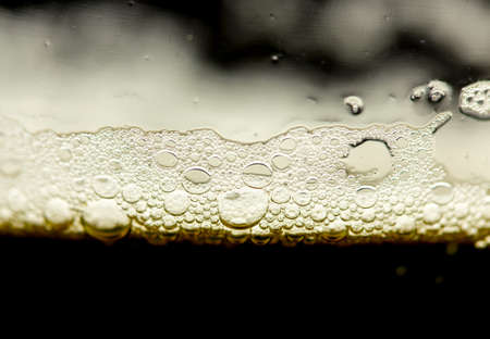 foam of dark beer with bubbles