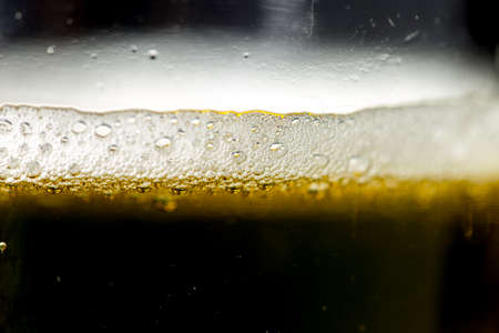 foam of dark beer with bubblesの写真素材