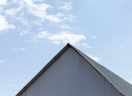 Roof of a house on a blue sky backgroundの写真素材