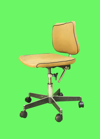 Old computer chair isolated on a green backgroundの写真素材