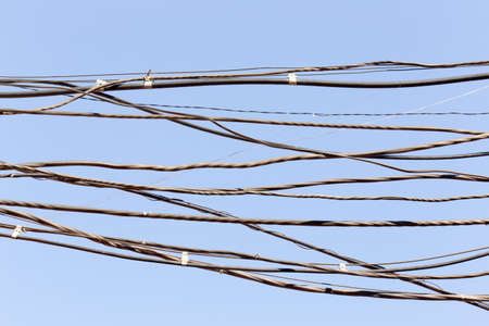 an electric wire against a blue skyの写真素材