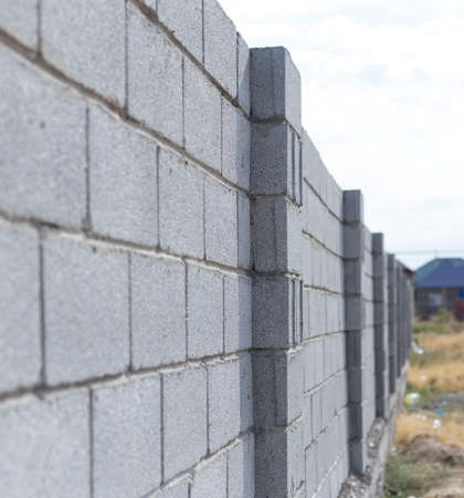Gray fence made of brick wall