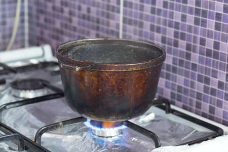 dirty cast iron pot in the open airの写真素材