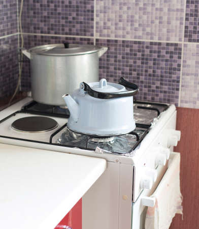 on the gas stove the kettle and cast-iron panの写真素材