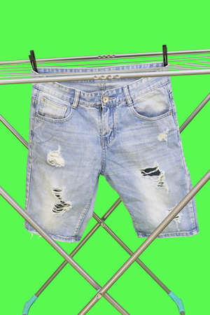 Dryer for clean linen isolated on a green backgroundの写真素材