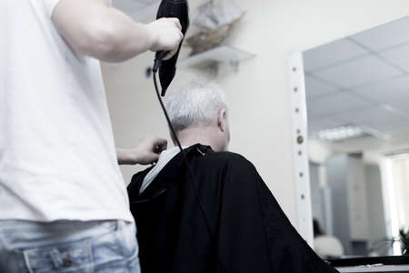 Hairdresser, master works with clientsの写真素材