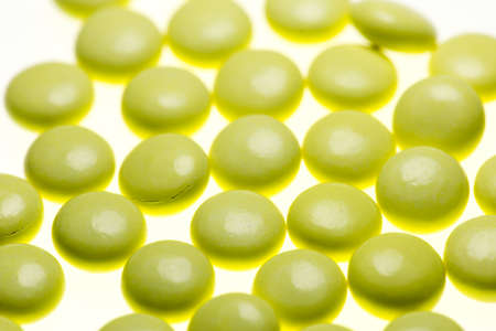 bottle of yellow medical valerian pills on a white background, herb medicineの写真素材