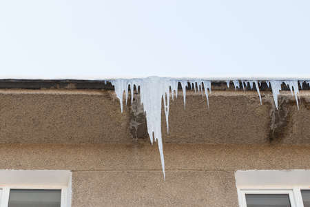 icicles which are hanging down from a roofの写真素材