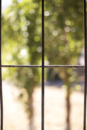 open window with grilles and hitting the sun beamの写真素材