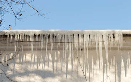 icicles which are hanging down from a roofの写真素材
