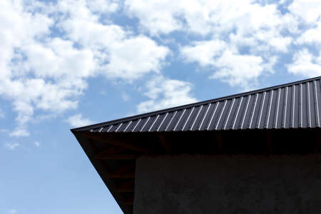 Roof of a house on a blue sky backgroundの写真素材