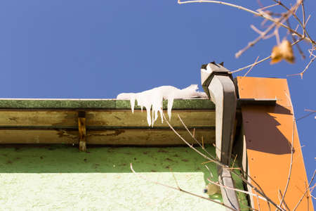 icicles which are hanging down from a roofの写真素材