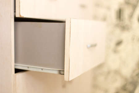 cupboard with opened empty drawerの写真素材
