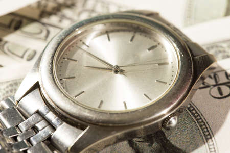 expensive watches in the background of one hundred dollarの写真素材