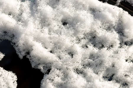 parked car covered with snow during snowing in winter timeの写真素材