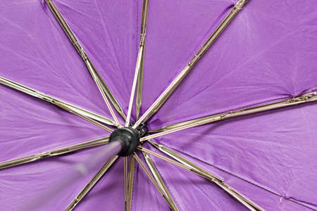 The inside of an open purple umbrellaの写真素材