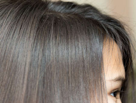 Close up of an attractive young woman looking through hairの写真素材