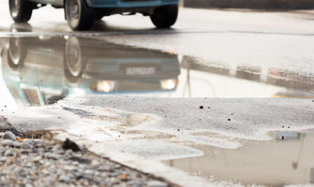bad wet asphalt on the roadの写真素材