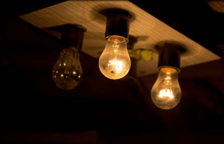 light bulb lit on a black background ,soft focusの写真素材