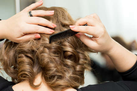 Girl combing her hair without looking at the camera