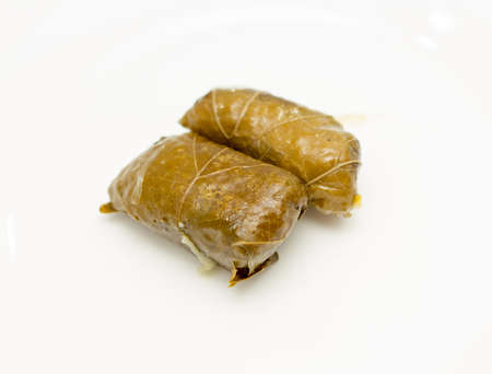 dolma, stuffed grape leaves on a white background