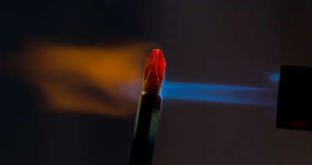 Screwdriver lit under a stream of fireの写真素材