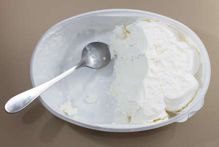 creamy ice cream in a bowl and spoon