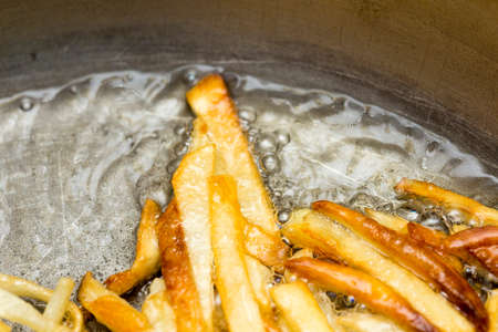 French fries fried in a panの写真素材