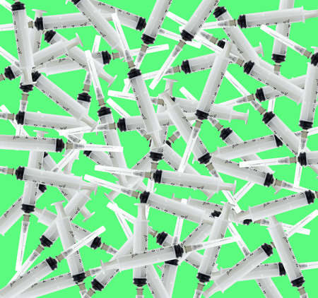 a lot of syringes on a green backgroundの写真素材