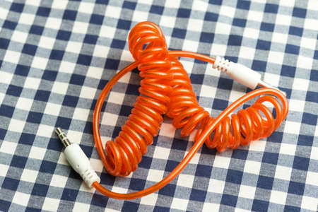 aux cable on the background of checkered fabric