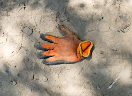 dirty construction glove on the groundの写真素材