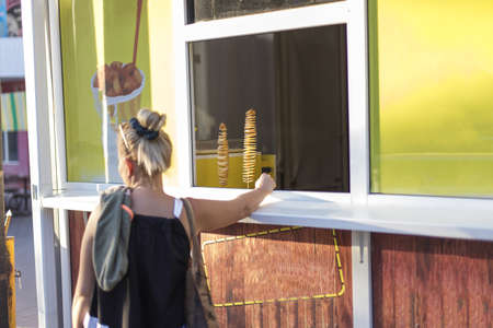 woman buying chips with a spiral shape