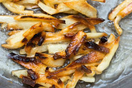 French fries fried in a panの写真素材